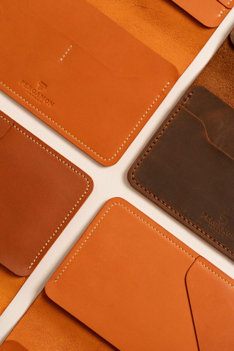A top view of a collection of luxury leather wallets and cardholders showcasing craftsmanship and elegance.